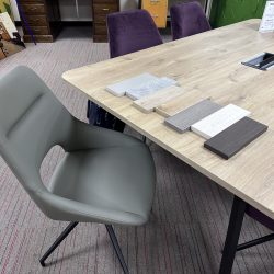A wood meeting table with multiple wood finishes in different colours.