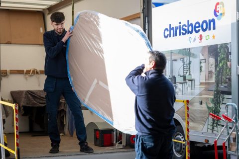 Office furniture being loaded into a Chrisbeon delivery van at the Telford warehouse for delivery to a customer.